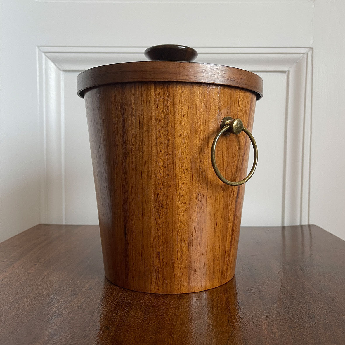 A very cool Vintage Scandinavian Teak Ice Bucket by KMC. Tapered to the base with two brass ring handles to the sides and a teak knob on the lid. Inside is aluminium lined to keep the ice nice and cold. Marked on the bottom with the horse logo - SHOP NOW - www.intovintage.co.uk