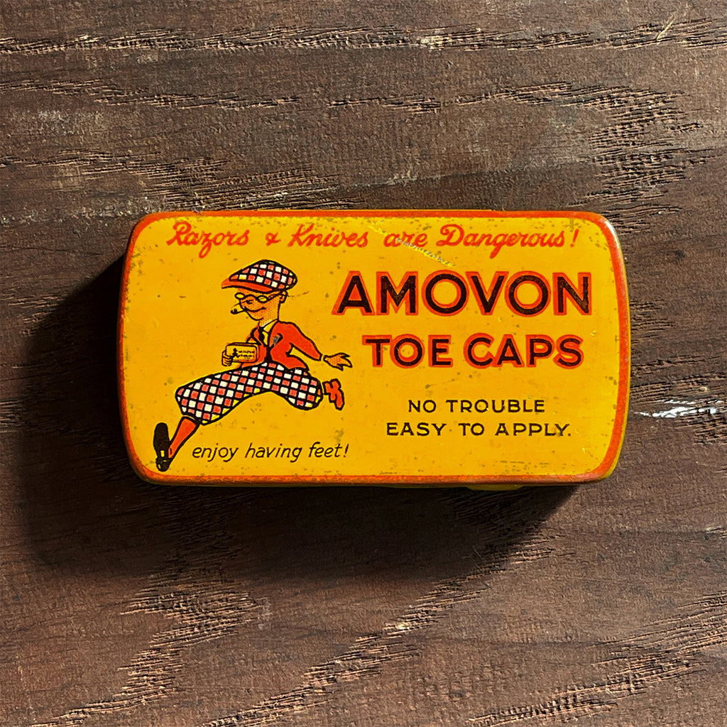 A vintage Amovon Toe Caps Tin from the 1930s with a great graphic to the front. Hinged lid and original contents. - SHOP NOW - www.intovintage.co.uk