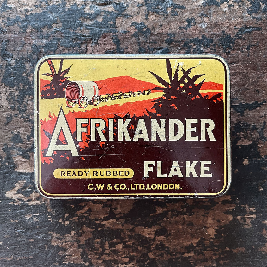 A fresh looking vintage Afrikander Ready Rubbed Flake Tin from the 1930s with a great colours and graphics to the front and inside hinged lid - SHOP NOW - www.intovintage.co.uk