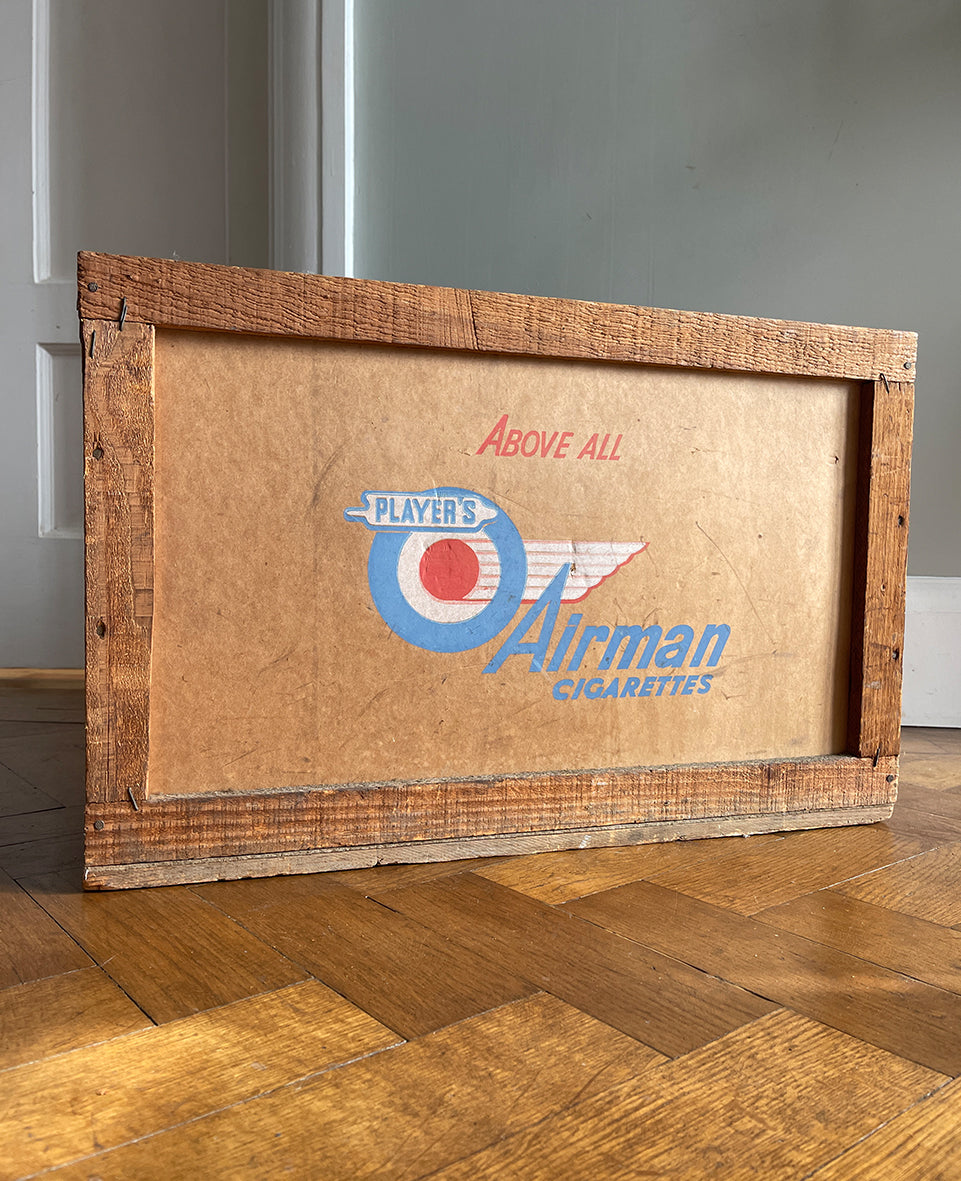 A 1950s Players Airman's Cigarettes Delivery Crate in excellent condition. With the Player's Airman logo to the main sides panels and the Player's Navy Cut logo on one of the end panels. The opposite end has the original delivery label still stuck to it. Great for general storage or a cool log box for beside the fire - SHOP NOW - www.intovintage.co.uk
