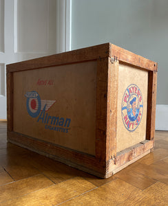 A 1950s Players Airman's Cigarettes Delivery Crate in excellent condition. With the Player's Airman logo to the main sides panels and the Player's Navy Cut logo on one of the end panels. The opposite end has the original delivery label still stuck to it. Great for general storage or a cool log box for beside the fire - SHOP NOW - www.intovintage.co.uk