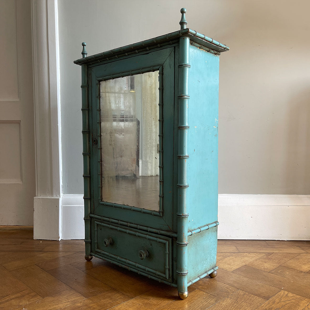 A Pretty Chinese inspired Wall Cabinet in its original paint and with original mirror plate. The cabinet is Chinese inspired, with bamboo edge detailing, golden globe feet and turned finials on top. It is finished in a beautiful and perfectly aged duck egg blue, and the original mirror plate - SHOP NOW - www.intovintage.co.uk