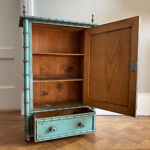 A Pretty Chinese inspired Wall Cabinet in its original paint and with original mirror plate. The cabinet is Chinese inspired, with bamboo edge detailing, golden globe feet and turned finials on top. It is finished in a beautiful and perfectly aged duck egg blue, and the original mirror plate - SHOP NOW - www.intovintage.co.uk