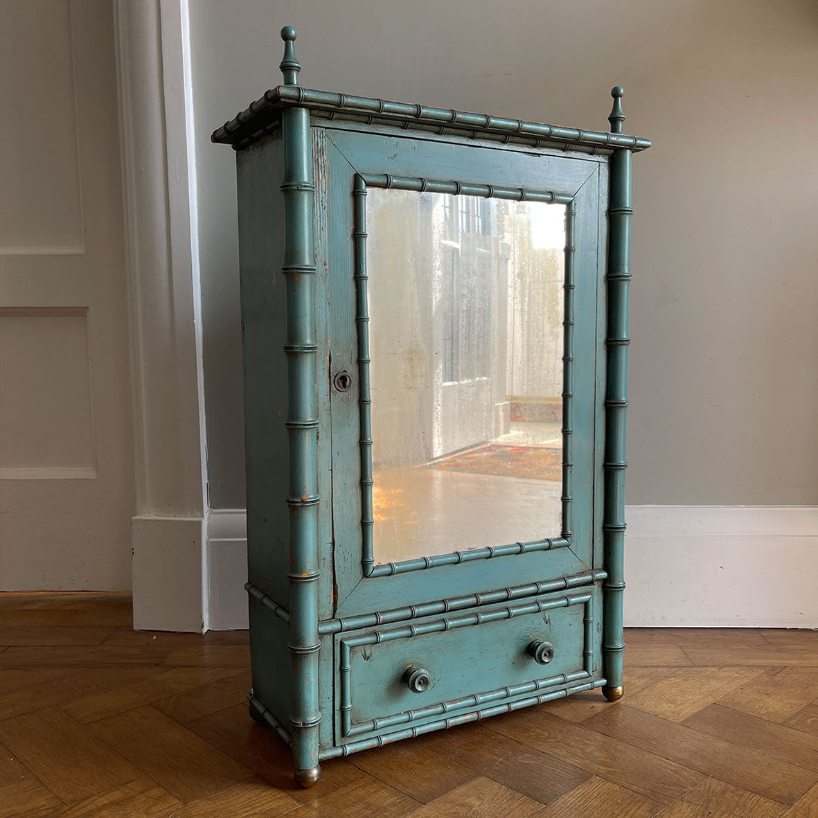 A Pretty Chinese inspired Wall Cabinet in its original paint and with original mirror plate. The cabinet is Chinese inspired, with bamboo edge detailing, golden globe feet and turned finials on top. It is finished in a beautiful and perfectly aged duck egg blue, and the original mirror plate - SHOP NOW - www.intovintage.co.uk