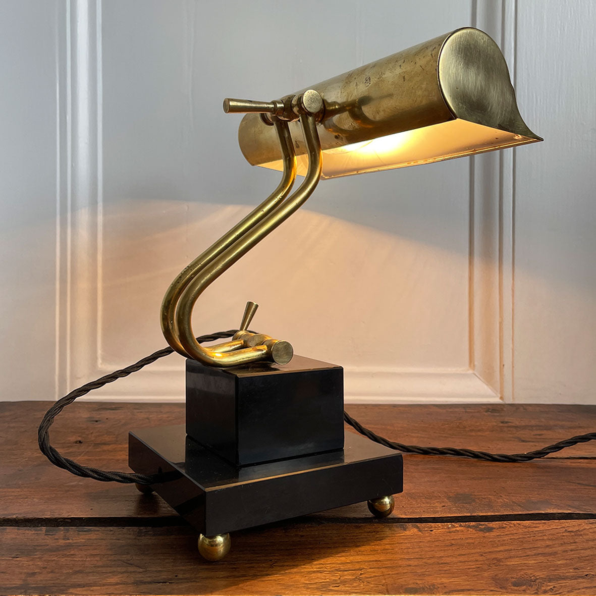 A smart looking Brass and fully adjustable Bankers Lamp with two stepped black marble base and brass bun feet. The lamp has been rewired with new material covered black cord and plug - SHOP NOW - www.intovintage.co.uk