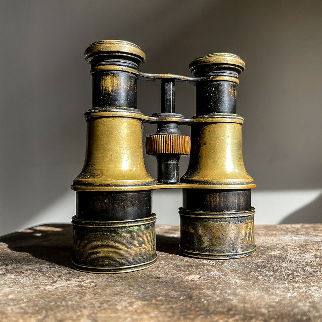 A pair of Victorian Negretti and Zambra binoculars. Made from brass and have a patinated black finish to the brass that has worn away over the years.The mark of NEGRETTI & ZAMBRA -OPTICIANS TO THE QUEEN appears around the rim of one of the eye pieces and 'ADJUSTED IN LONDON' around the other. - SHOP NOW - www.intovintage.co.uk