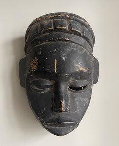 A good looking Tribal Mask. The face has a beautiful simplicity to it with slit eyes and a prominent nose. A stylised crown sits atop of the head. finely carved with a black painted finish - SHOP NOW - www.intovintage.co.uk