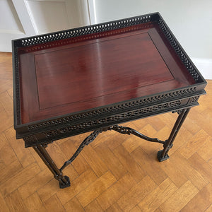 A nice little decorative table in black ebonised finish in the style of Thomas Chippendale. It has a pierced wood gallery top that surrounds a natural mahogany top. The sides have carved fret work and sit atop trefoil legs - SHOP NOW - www.intovintage.co.uk