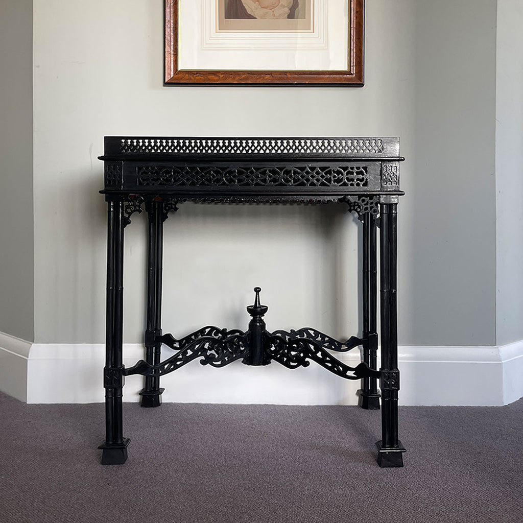 A nice little decorative table in black ebonised finish in the style of Thomas Chippendale. It has a pierced wood gallery top that surrounds a natural mahogany top. The sides have carved fret work and sit atop trefoil legs - SHOP NOW - www.intovintage.co.uk