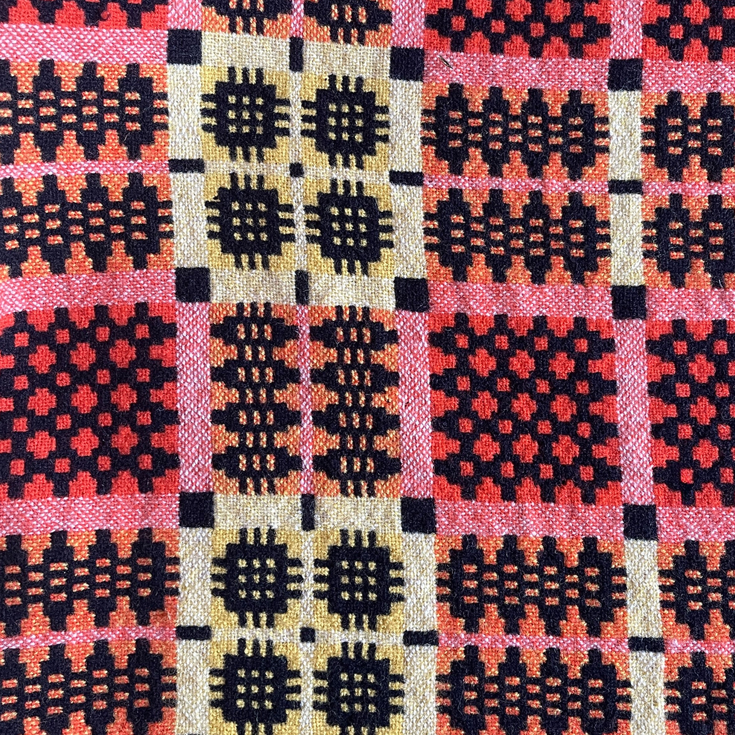 A pure wool Welsh Tapestry blanket in Black, Orange, Red, White and Yellow - SHOP NOW - www.intovintage.co.uk