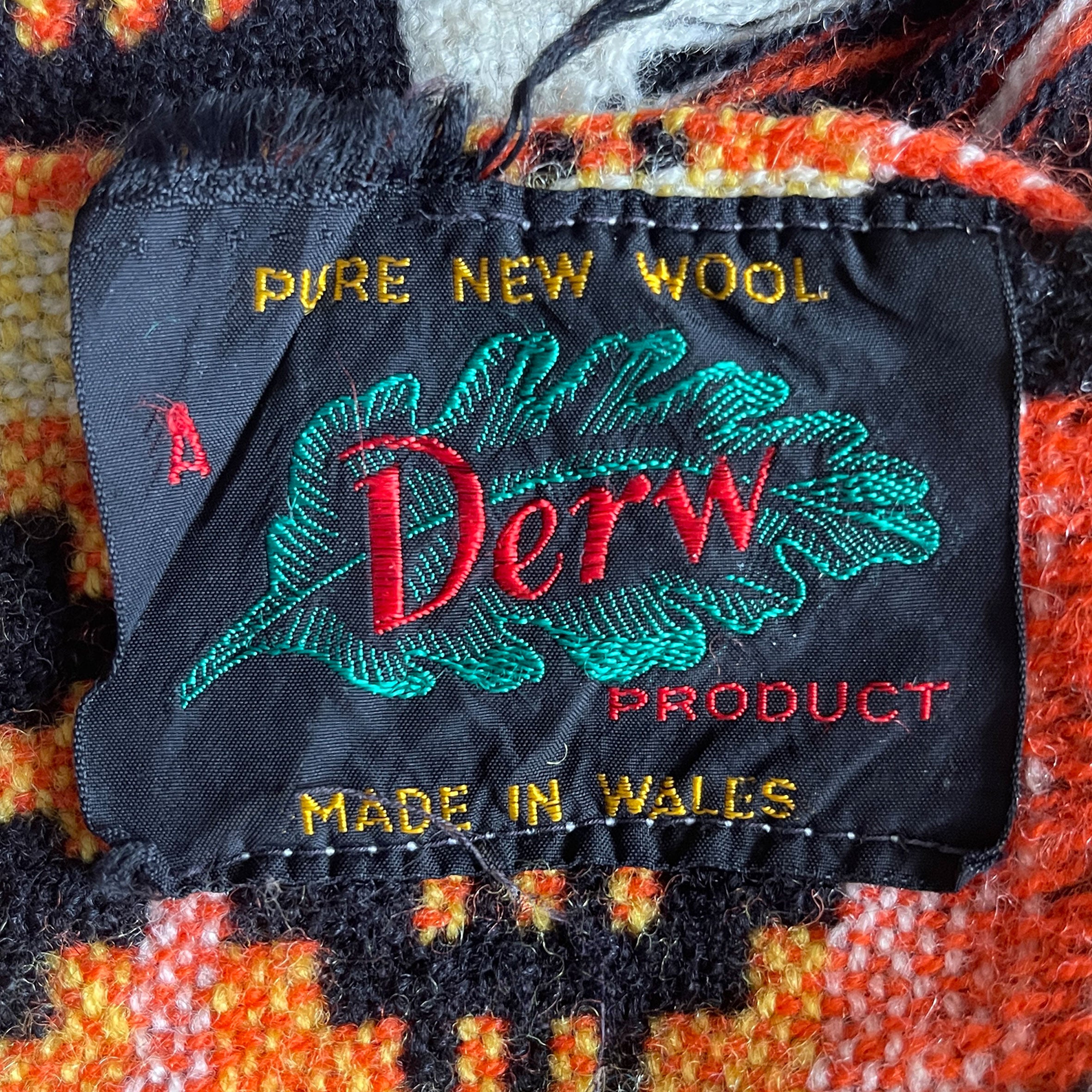 A pure wool Welsh Tapestry blanket in Black, Orange, Red, White and Yellow - SHOP NOW - www.intovintage.co.uk