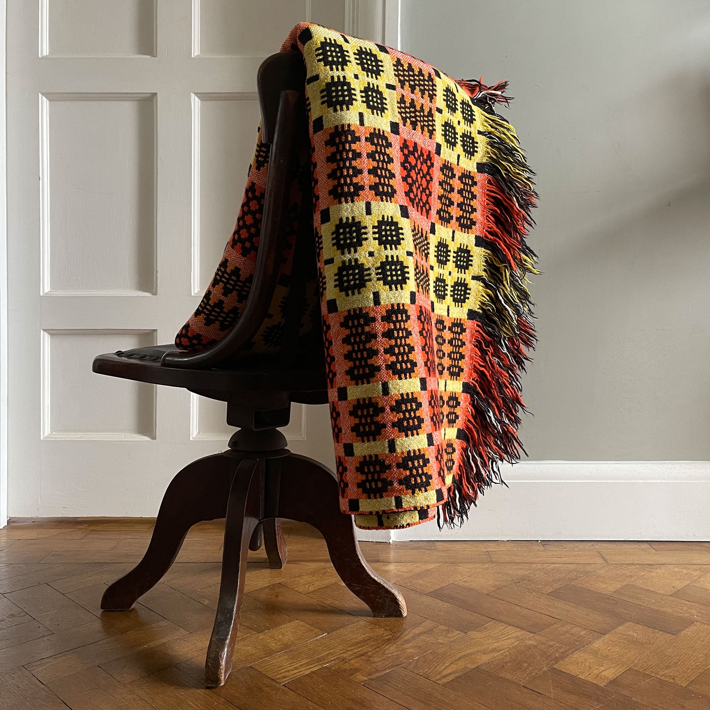 A pure wool Welsh Tapestry blanket in Black, Orange, Red, White and Yellow - SHOP NOW - www.intovintage.co.uk