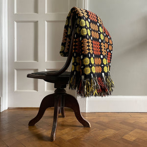 A pure wool Welsh Tapestry blanket in Black, Orange, Red, White and Yellow - SHOP NOW - www.intovintage.co.uk