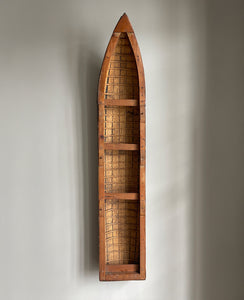 A vintage scratch built long boat. Of a ribbed and planked construction with three seats and a painted canvas hull. The boat has an added string so that it can be hung on the wall as a piece of art. A fascinating item - SHOP NOW - www.intovintage.co.uk
