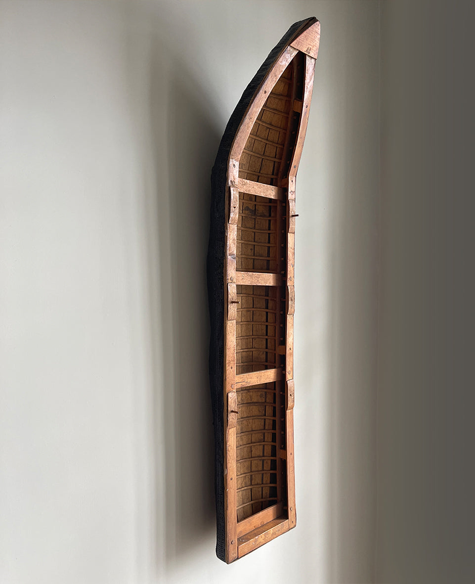 A vintage scratch built long boat. Of a ribbed and planked construction with three seats and a painted canvas hull. The boat has an added string so that it can be hung on the wall as a piece of art. A fascinating item - SHOP NOW - www.intovintage.co.uk