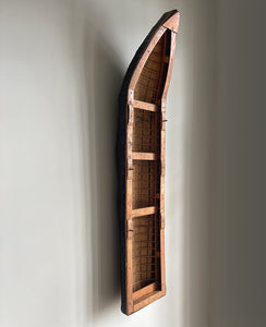 A vintage scratch built long boat. Of a ribbed and planked construction with three seats and a painted canvas hull. The boat has an added string so that it can be hung on the wall as a piece of art. A fascinating item - SHOP NOW - www.intovintage.co.uk