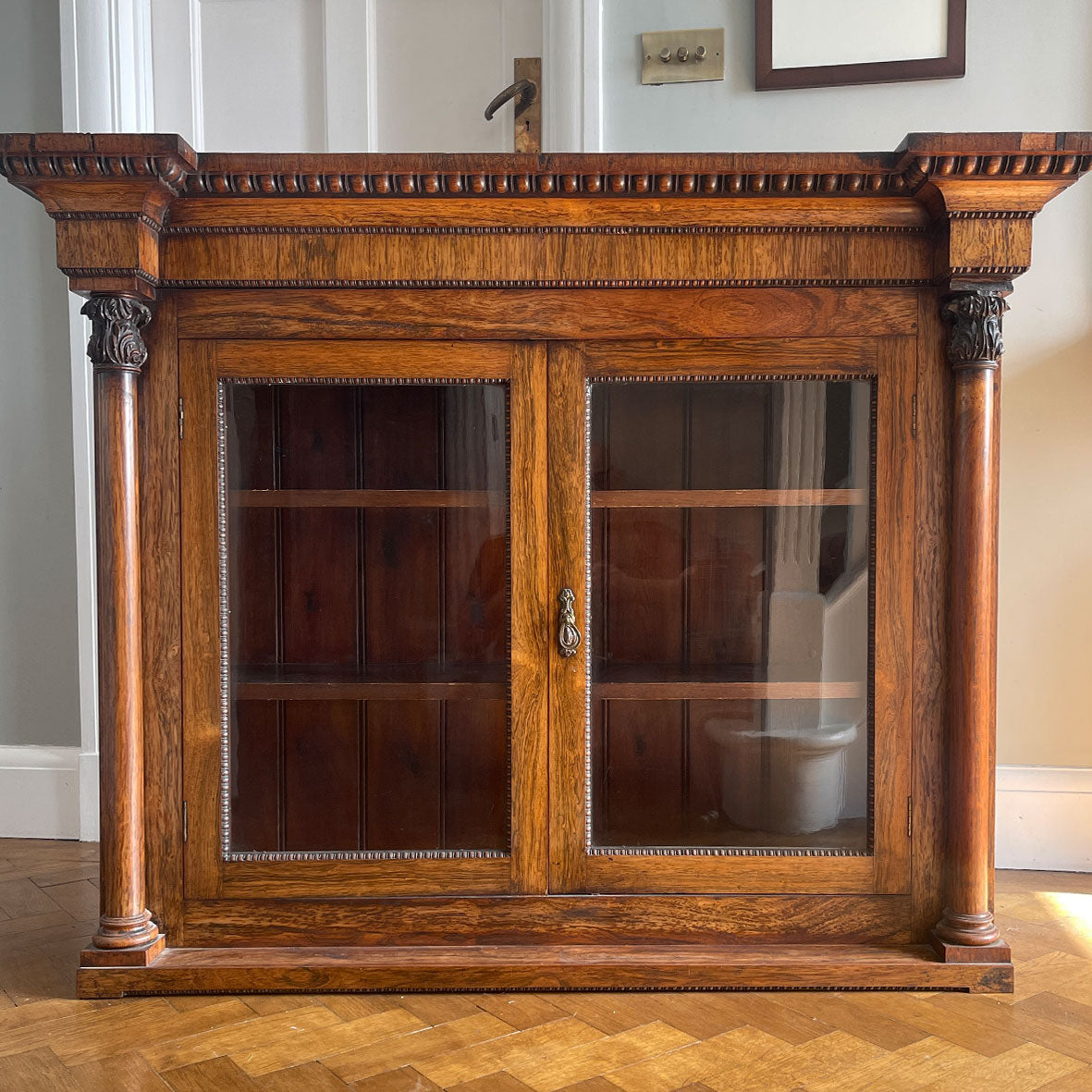 A good looking Victorian Rosewood Bookcase. Two original glazed doors are framed by a classical egg & dart cornice freeze to the top and two decorative solid rosewood columns each side - SHOP NOW - www.intovintage.co.uk