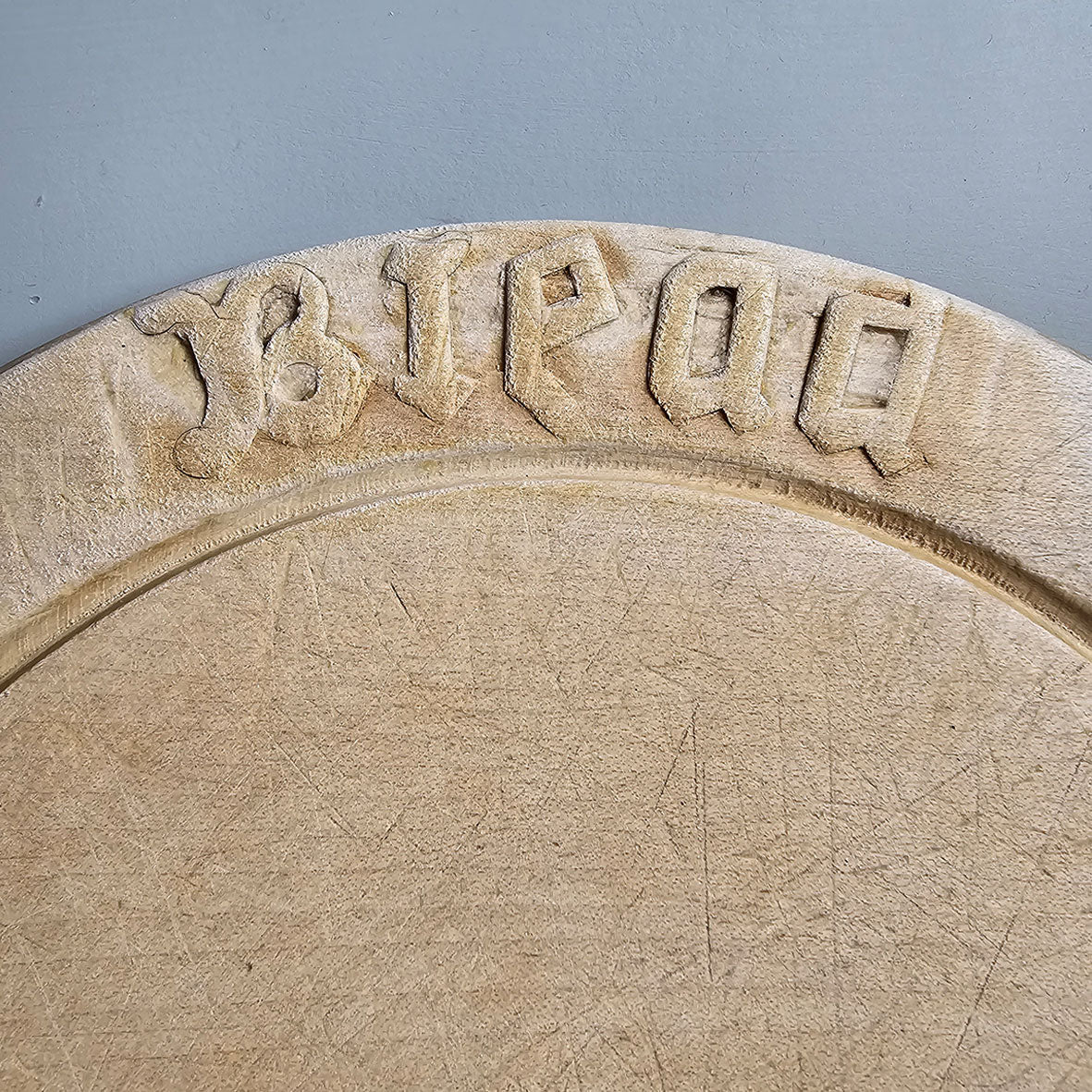An Edwardian Carved Sycamore Bread Board with the word 'Bread' and a bottom rosette carved on its border - Nicely worn with a pale patina - SHOP NOW - www.intovintage.co.uk