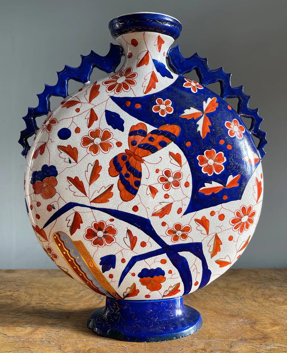 An Imari Moon Vase with a hand painted butterfly design. Beautiful blue and red designs to both sides. Decorative blue zig zag styled handles come down each of the sides. A striking decorative piece that would bring a splash of colour to any space - SHOP NOW - www.intovintage.co.uk