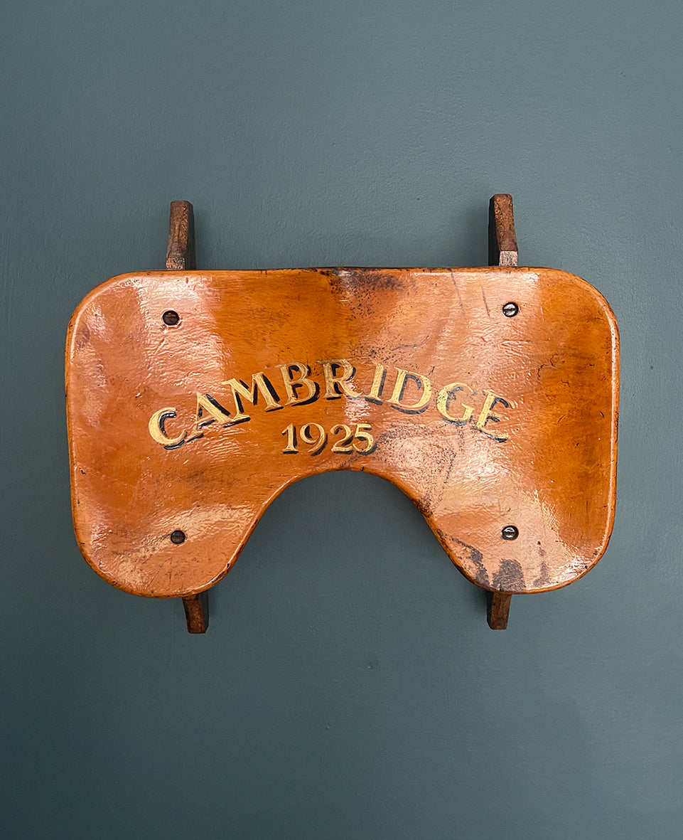 An Original 100 year old Boat Seat with the legend 'CAMBRIDGE 1925' hand painted in gold letters with a black drop shadow to the seat area. The seat section remains still attached to it's under side slide roller mechanism with wheels - SHOP NOW - www.intovintage.co.uk