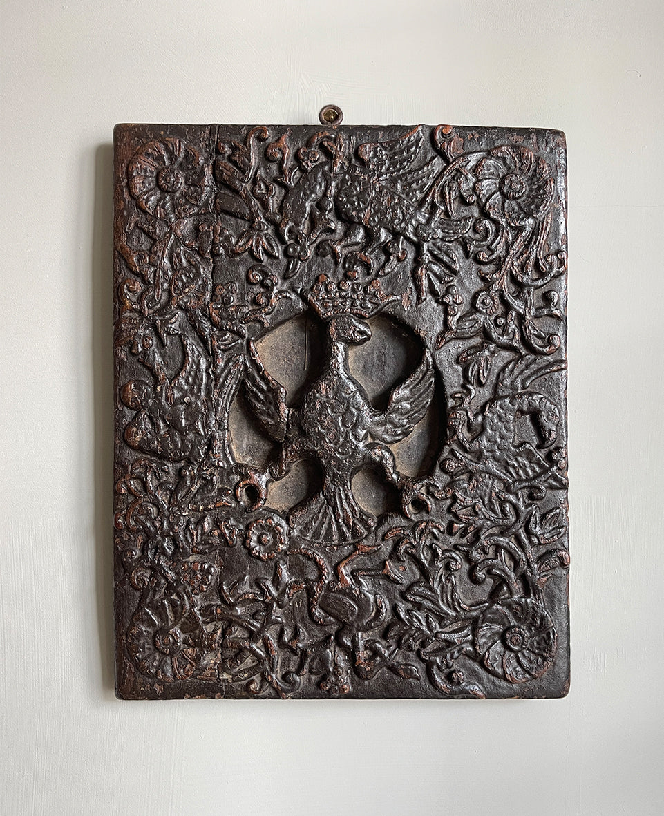 An interesting 17th Century Carved Oak Panel that once would have been the door off of a piece of furniture. The hinge and escutcheon marks are still visible on the reverse. The center sees a crowned eagle surrounded by climbing roses with four larger roses in each corner. Look closer and you'll see other birds and a cupid within the foliage - SHOP NOW - www.intovintage.co.uk