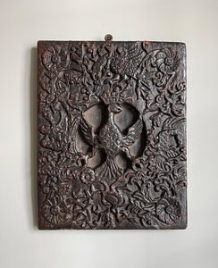 An interesting 17th Century Carved Oak Panel that once would have been the door off of a piece of furniture. The hinge and escutcheon marks are still visible on the reverse. The center sees a crowned eagle surrounded by climbing roses with four larger roses in each corner. Look closer and you'll see other birds and a cupid within the foliage - SHOP NOW - www.intovintage.co.uk