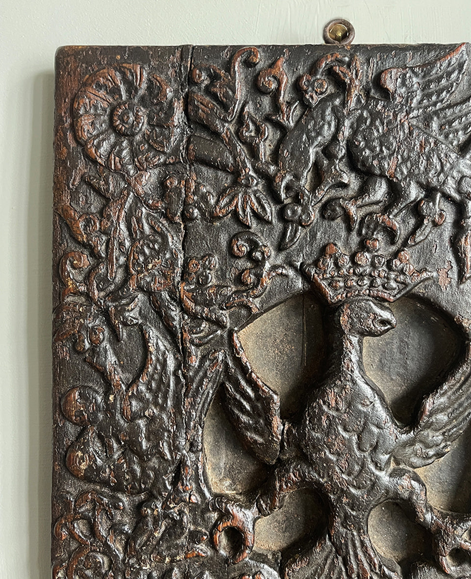 An interesting 17th Century Carved Oak Panel that once would have been the door off of a piece of furniture. The hinge and escutcheon marks are still visible on the reverse. The center sees a crowned eagle surrounded by climbing roses with four larger roses in each corner. Look closer and you'll see other birds and a cupid within the foliage - SHOP NOW - www.intovintage.co.uk