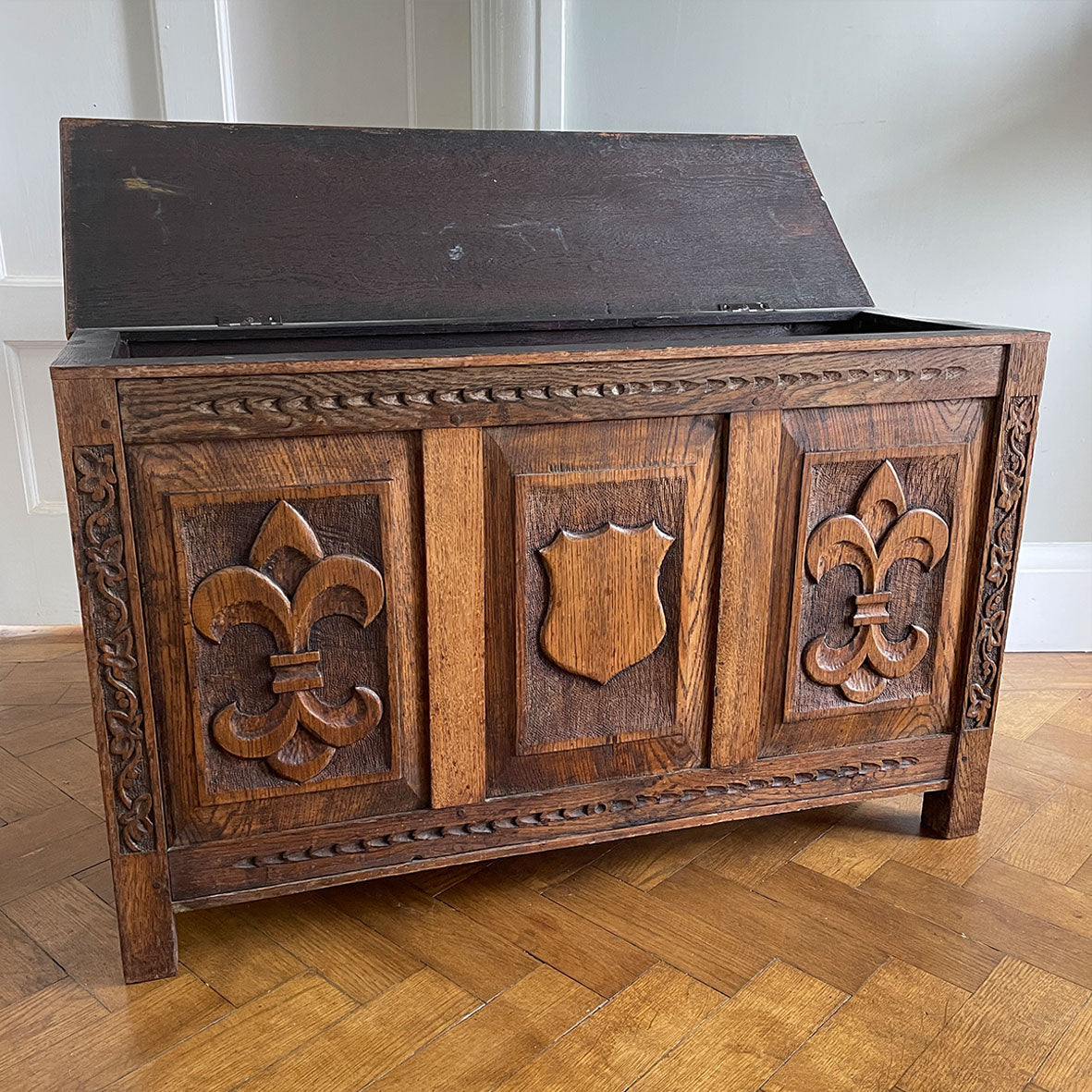 A solid oak chest with fleur de lis and shield carving to the front. Very solid and very heavy! Perfect for a large flat screen TV or for the hallway to keep your boots and shoes in. COMPOSITION: Solid Oak DIMENSIONS: (L) 93.5cm (W) 32cm (H) 59cm - SHOP NOW - www.intovintage.co.uk