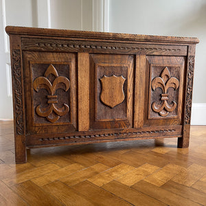 A solid oak chest with fleur de lis and shield carving to the front. Very solid and very heavy! Perfect for a large flat screen TV or for the hallway to keep your boots and shoes in. COMPOSITION: Solid Oak DIMENSIONS: (L) 93.5cm (W) 32cm (H) 59cm - SHOP NOW - www.intovintage.co.uk