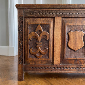 A solid oak chest with fleur de lis and shield carving to the front. Very solid and very heavy! Perfect for a large flat screen TV or for the hallway to keep your boots and shoes in. COMPOSITION: Solid Oak DIMENSIONS: (L) 93.5cm (W) 32cm (H) 59cm - SHOP NOW - www.intovintage.co.uk