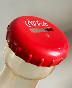 A Very Large Vintage Coke Bottle made from a clear plastic with a red plastic cap lid that has a slot in it so that you can collect your loose change - SHOP NOW - www.intovintage.co.uk