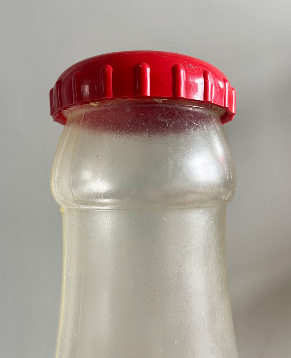 A Very Large Vintage Coke Bottle made from a clear plastic with a red plastic cap lid that has a slot in it so that you can collect your loose change - SHOP NOW - www.intovintage.co.uk
