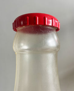 A Very Large Vintage Coke Bottle made from a clear plastic with a red plastic cap lid that has a slot in it so that you can collect your loose change - SHOP NOW - www.intovintage.co.uk