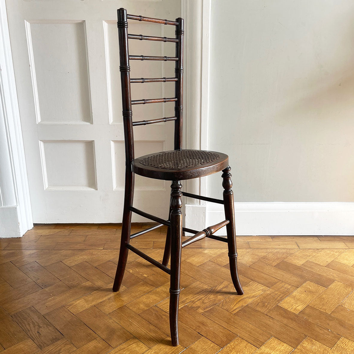 An exceptional example of an 19th Century deportment or correction chair. A beautifully turned ladder back, caned seat with turned and splayed legs. - SHOP NOW - www.intovintage.co.uk
