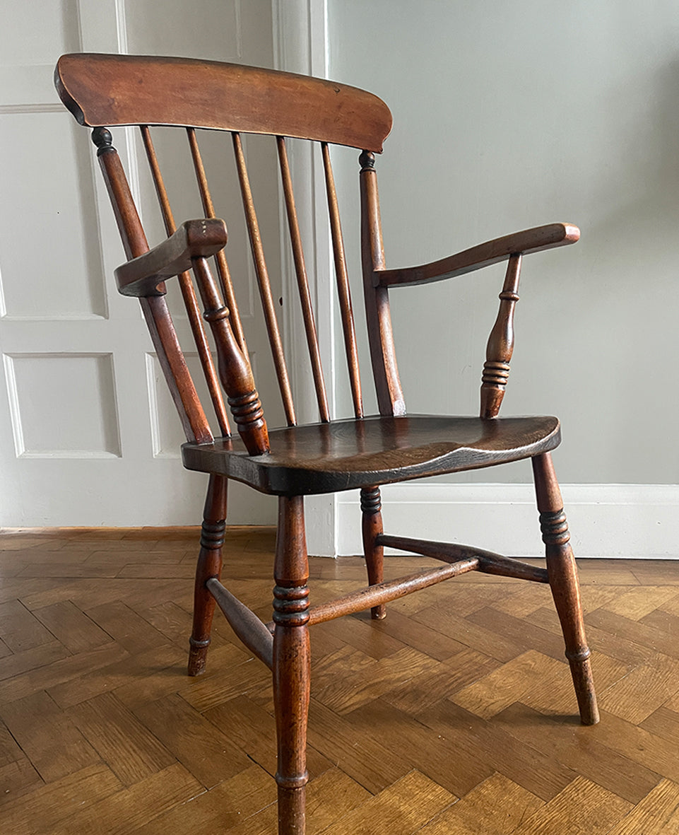 A traditional and much loved classic farmhouse carver chair featuring an elm wood seat, hand turned legs, back spindles with hand carved details. Stamped 'R.B 56' on the back - SHOP NOW - www.intovintage.co.uk