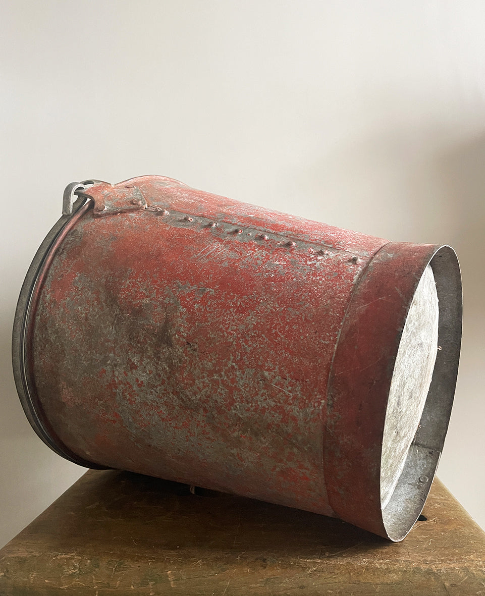 Vintage riveted, galvanised steel fire bucket with a wonderful distressed patina to it's red surface - SHOP NOW - www.intovintage.co.uk