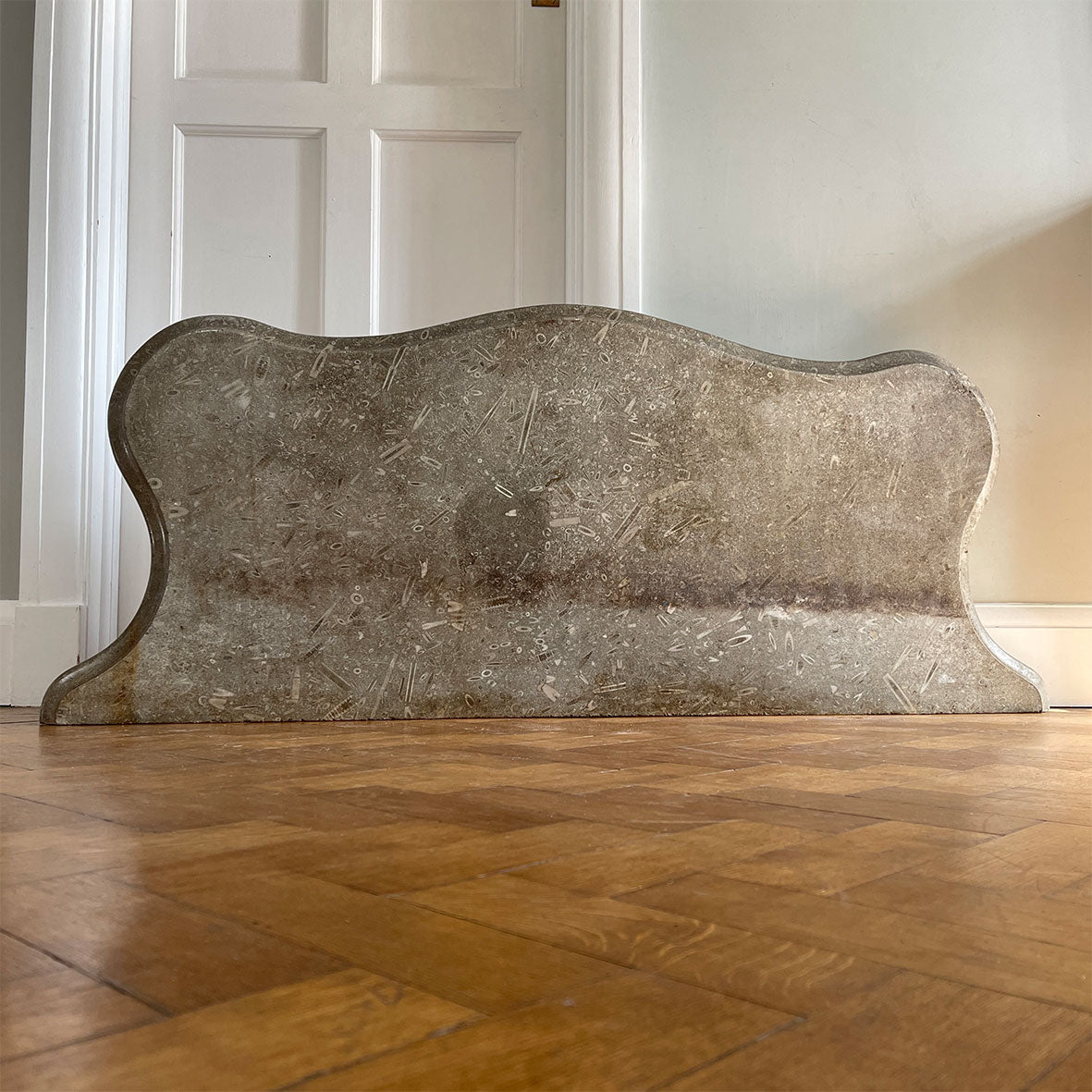 A large and beautiful slab of shaped mellow grey stone containing an abundance of orthoceras & ammonite fossils. It would have originally been atop a French Empire bombe chest of drawers - SHOP NOW - www.intovintage.co.uk