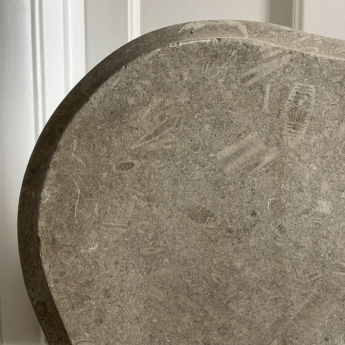 A large and beautiful slab of shaped mellow grey stone containing an abundance of orthoceras & ammonite fossils. It would have originally been atop a French Empire bombe chest of drawers - SHOP NOW - www.intovintage.co.uk