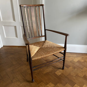 A solid beech Arts and Crafts Chair. Lathe back, rush seat, seven stretchers. Nice patina. A nicely designed and very sturdy chair - SHOP NOW - www.intovintage.co.uk