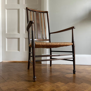 A solid beech Arts and Crafts Chair. Lathe back, rush seat, seven stretchers. Nice patina. A nicely designed and very sturdy chair - SHOP NOW - www.intovintage.co.uk