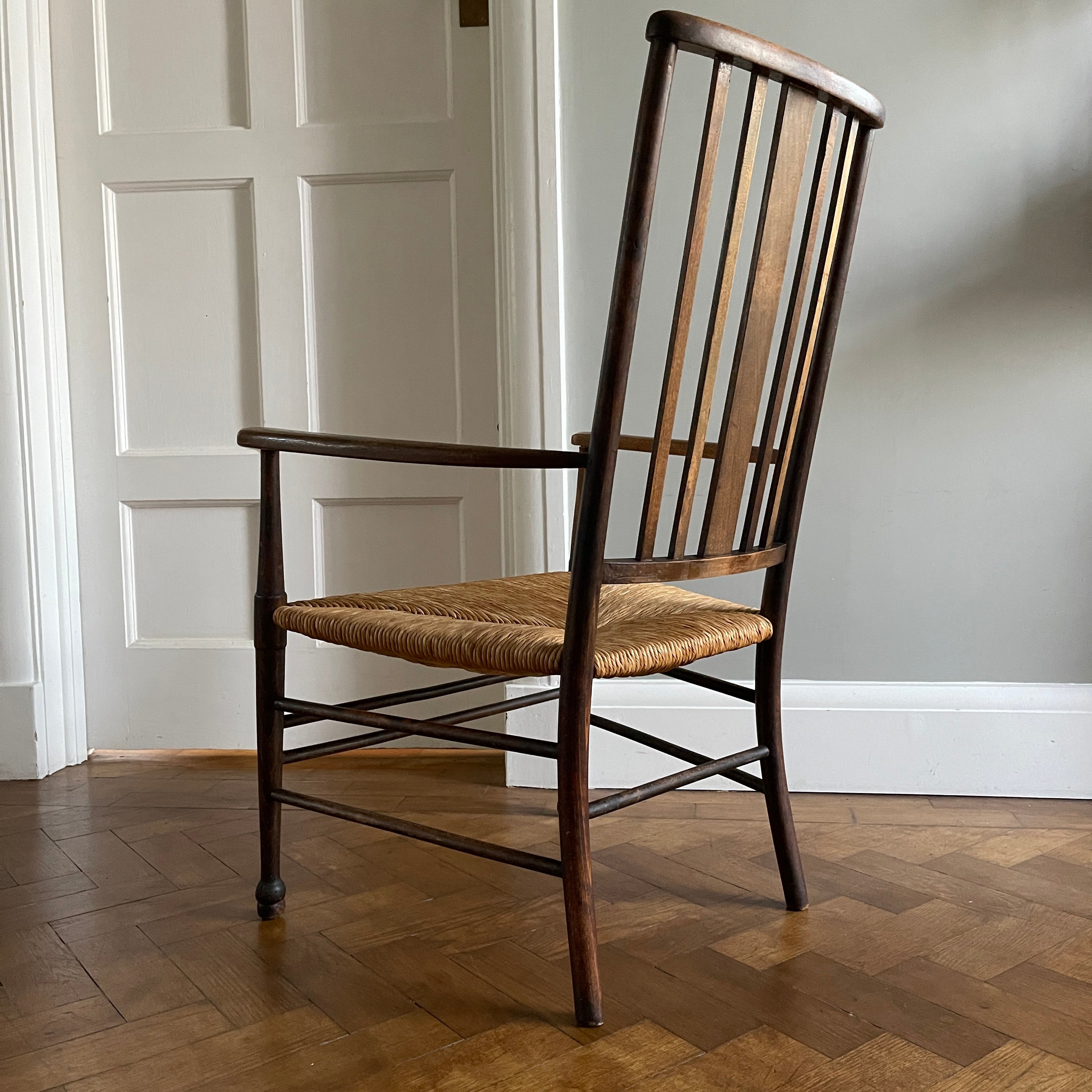 A solid beech Arts and Crafts Chair. Lathe back, rush seat, seven stretchers. Nice patina. A nicely designed and very sturdy chair - SHOP NOW - www.intovintage.co.uk