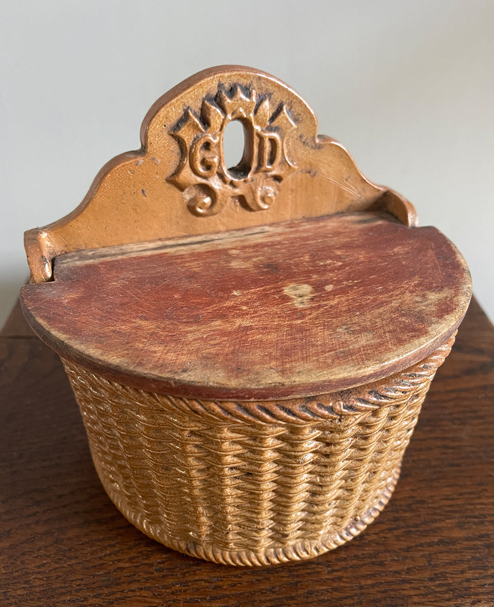 A delightful Late 19th Century Salt Box with a whicker design and hinged wooden lid. The word 'GOD' is visible on the back plate with the 'O' being the hole so that it can be mounted on the wall - SHOP NOW - www.intovintage.co.uk