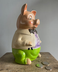A large 1950's Ellgreave Pottery Mr Pig Piggy Bank. Mr Pig is sporting vibrant green pants, a cream jacket, a lilac shirt with a chocolate brown bow tie. Marked 'Mr Pig - Ellgreave - England' to the base - SHOP NOW - www.intovintage.co.uk
