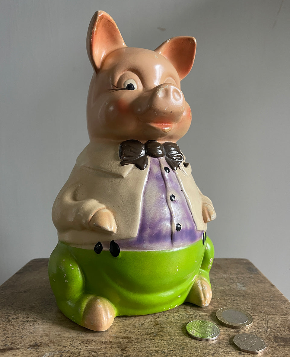 A large 1950's Ellgreave Pottery Mr Pig Piggy Bank. Mr Pig is sporting vibrant green pants, a cream jacket, a lilac shirt with a chocolate brown bow tie. Marked 'Mr Pig - Ellgreave - England' to the base - SHOP NOW - www.intovintage.co.uk