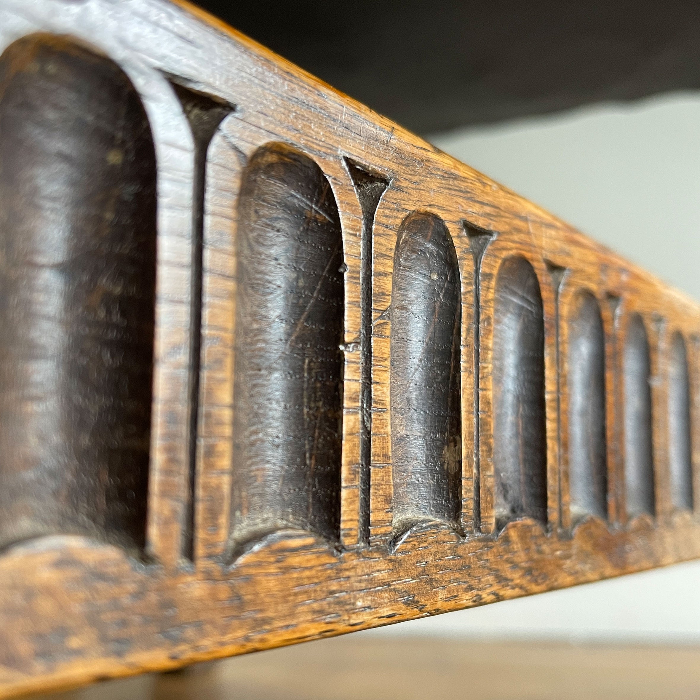 A super solid oak Arts and Crafts styled Carver Chair by the master furniture maker Rupert Griffiths. The style is known as 'Monastic' with this being a Swiss Stick back. The chair has its original leather seat and arms with big old brass studs holding it all in place. The frame is of oak and jointed with oak pegs - SHOP NOW - www.intovintage.co.uk