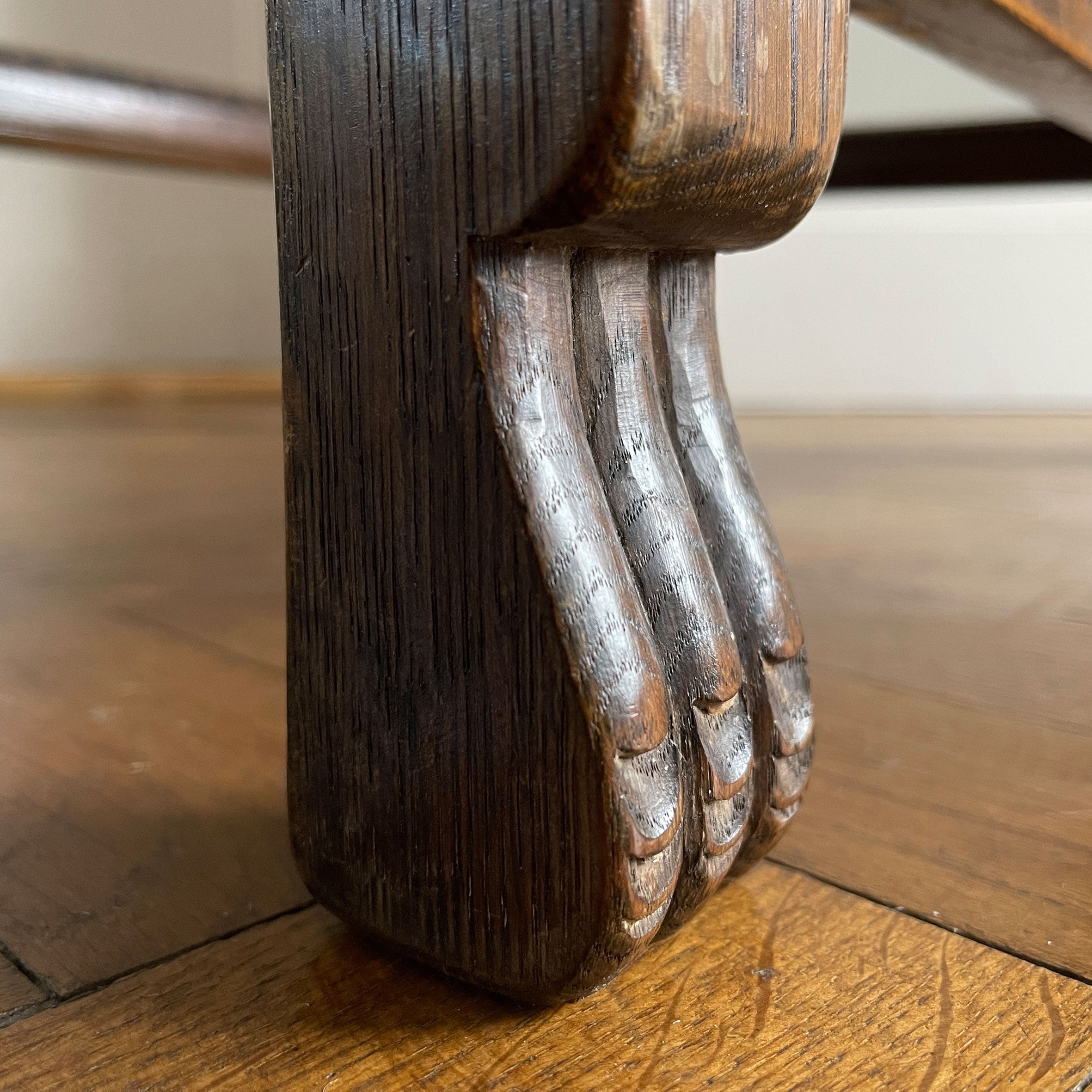 A super solid oak Arts and Crafts styled Carver Chair by the master furniture maker Rupert Griffiths. The style is known as 'Monastic' with this being a Swiss Stick back. The chair has its original leather seat and arms with big old brass studs holding it all in place. The frame is of oak and jointed with oak pegs - SHOP NOW - www.intovintage.co.uk