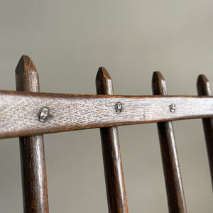 A super solid oak Arts and Crafts styled Carver Chair by the master furniture maker Rupert Griffiths. The style is known as 'Monastic' with this being a Swiss Stick back. The chair has its original leather seat and arms with big old brass studs holding it all in place. The frame is of oak and jointed with oak pegs - SHOP NOW - www.intovintage.co.uk