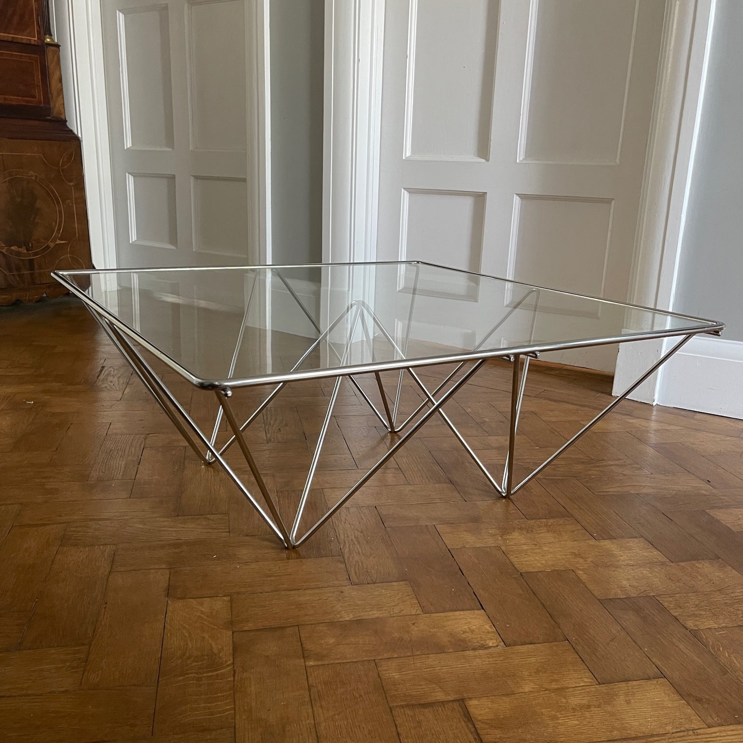 A stylish modernistic chromed square vintage coffee table in the Style of Paolo Piva circa 1980, Italy.Simple and elegant in form, the frame is made of chromed steel shaped connected triangles. Clear glass top - SHOP NOW - www.intovintage.co.uk