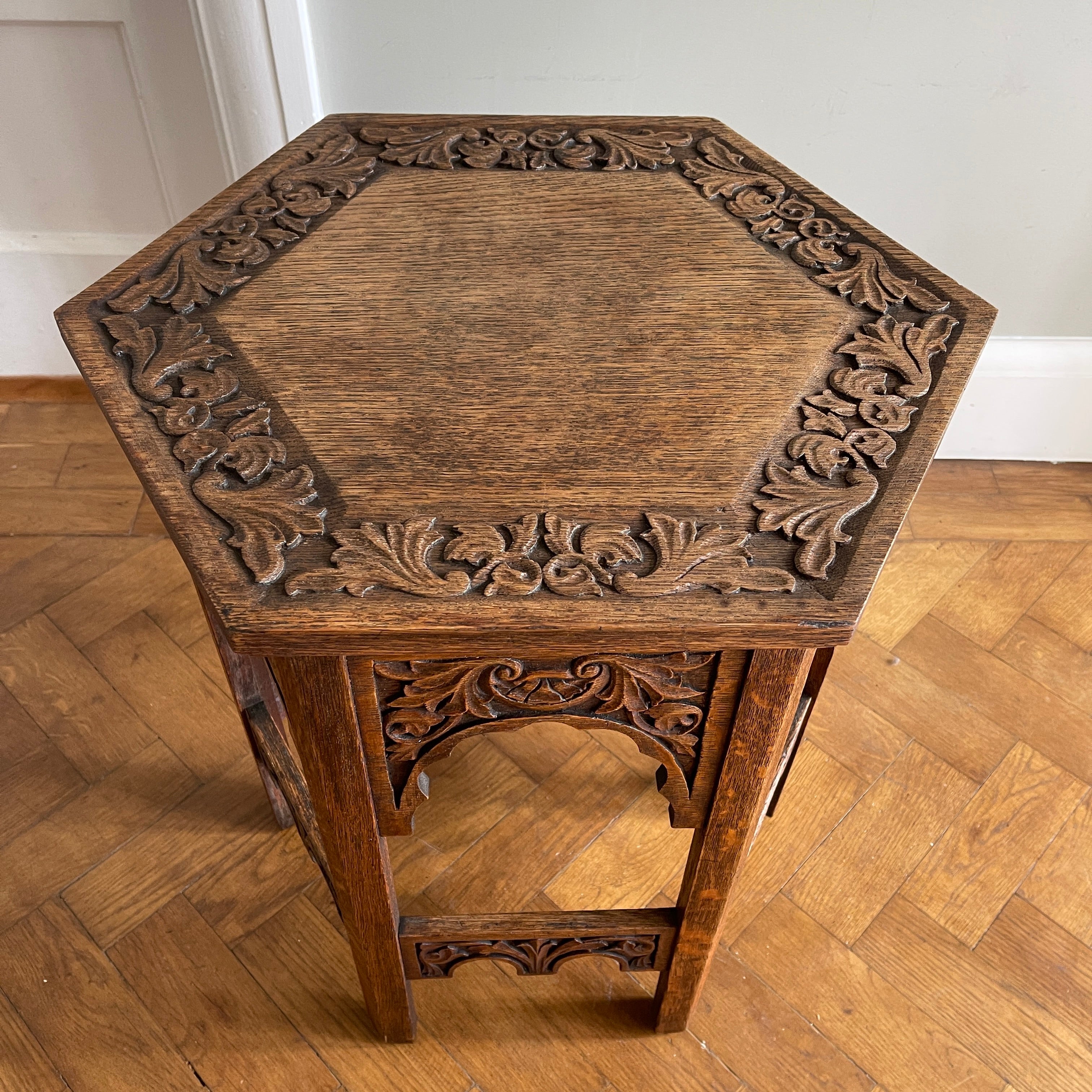 A good looking Carved Oak Side Table. The hexagonal top sees a beautiful hand-carved decorative leaf border with further carving to each of the six side panels. 