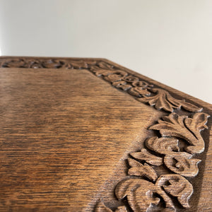 A good looking Carved Oak Side Table. The hexagonal top sees a beautiful hand-carved decorative leaf border with further carving to each of the six side panels. 